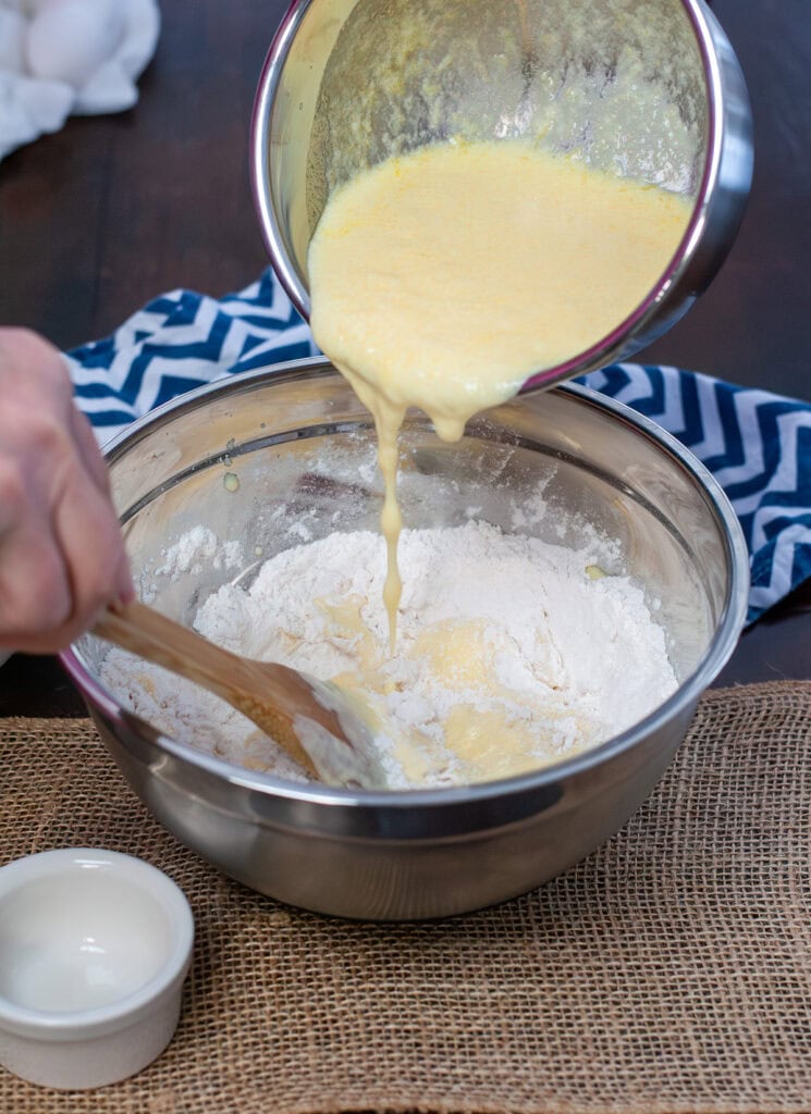 Egg mixture going into flour.
