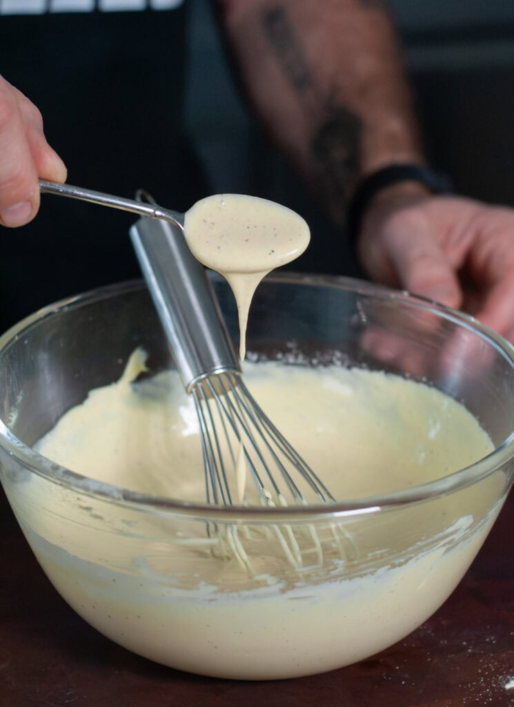 A scoop of sauce for baked potato salad.