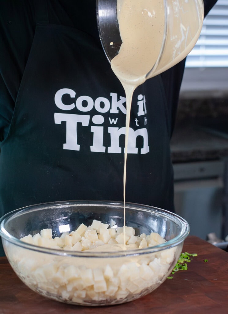 Sauce pouring into boiled potatoes.