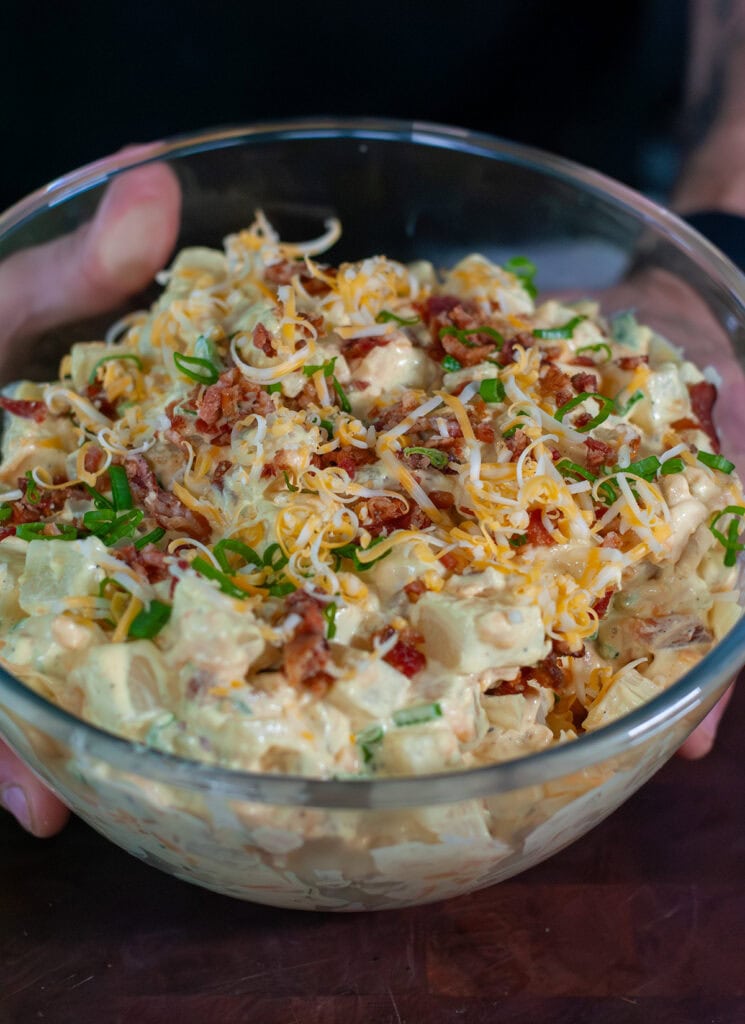 Loaded baked potato salad topped with bacon and chives.