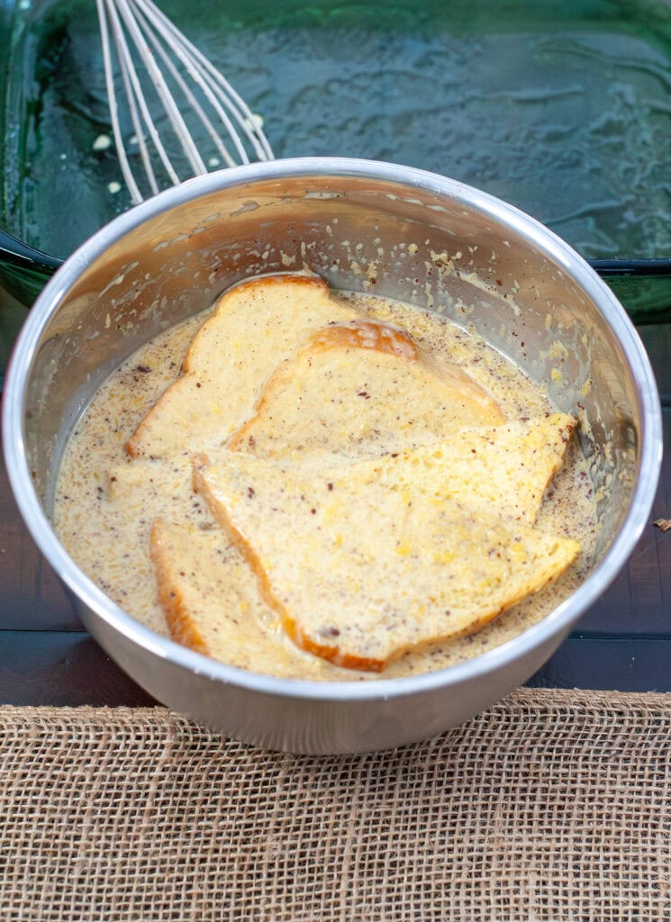 Toast soaking in French toast mixture.