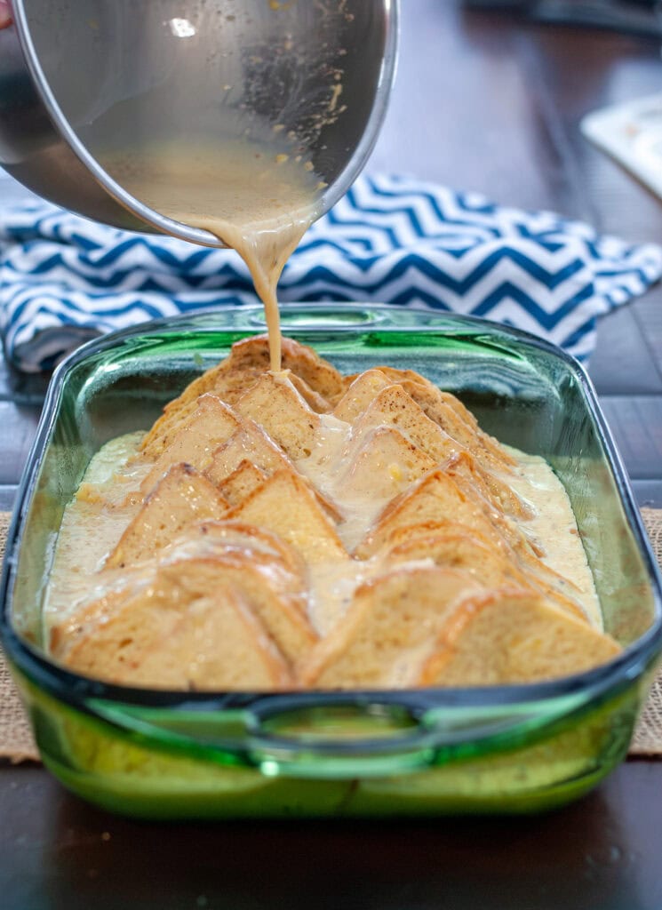 Liquid pouring over brioche slices.