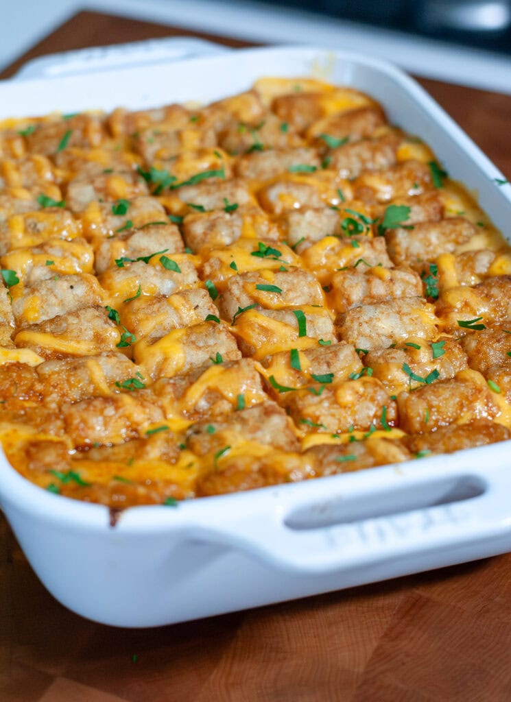 Cooked casserole with cheese and parsley on top.
