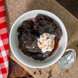 Crock pot lava cake with syrup and whipped cream.