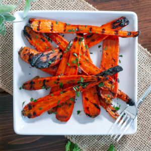 Grilled and glazed carrots topped with parsley.