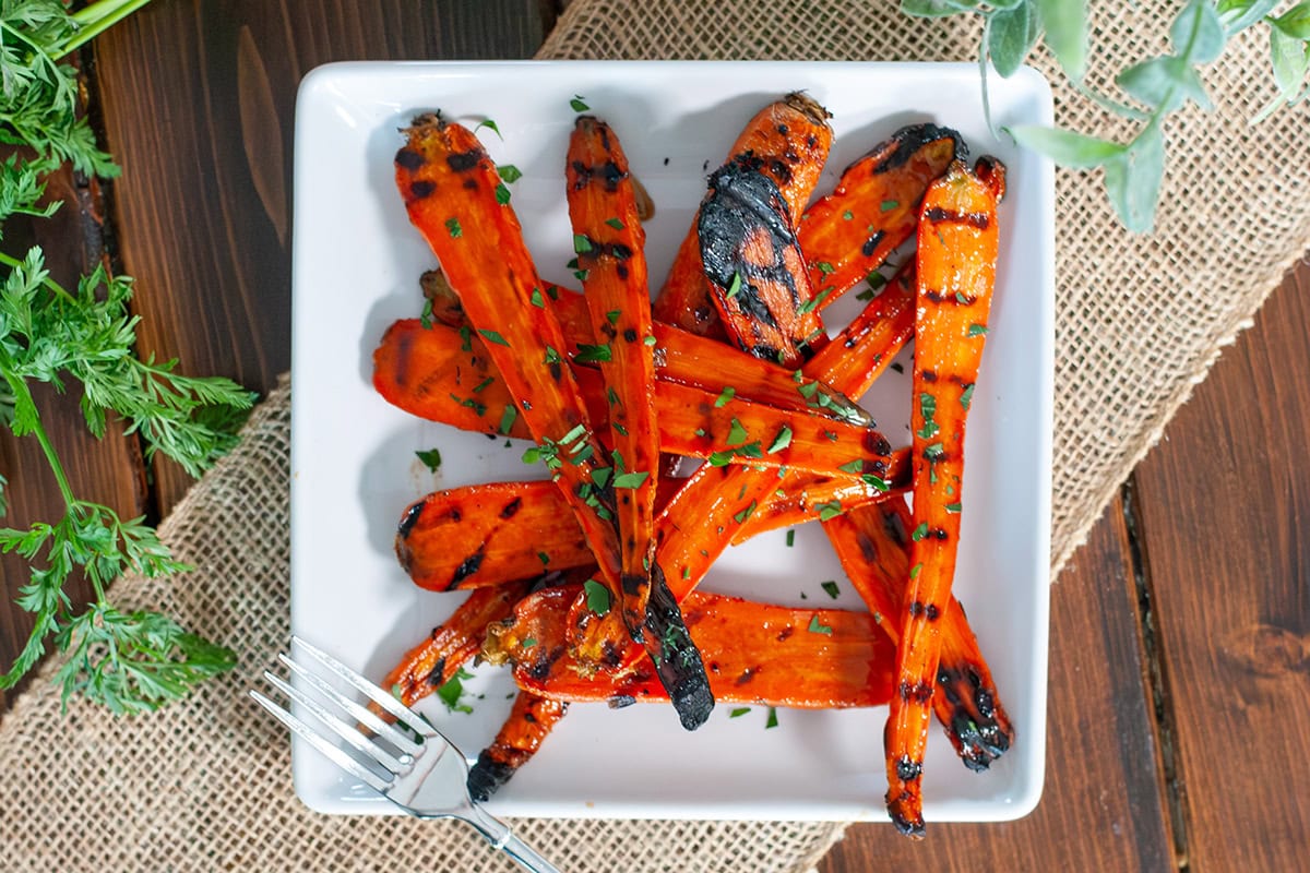 Grilled carrots topped with glaze and parsley.