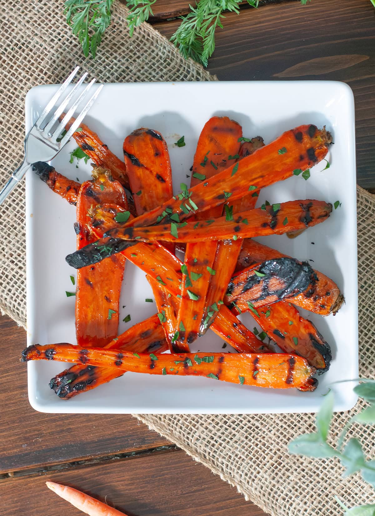 Grilled carrots on a plate with glaze.