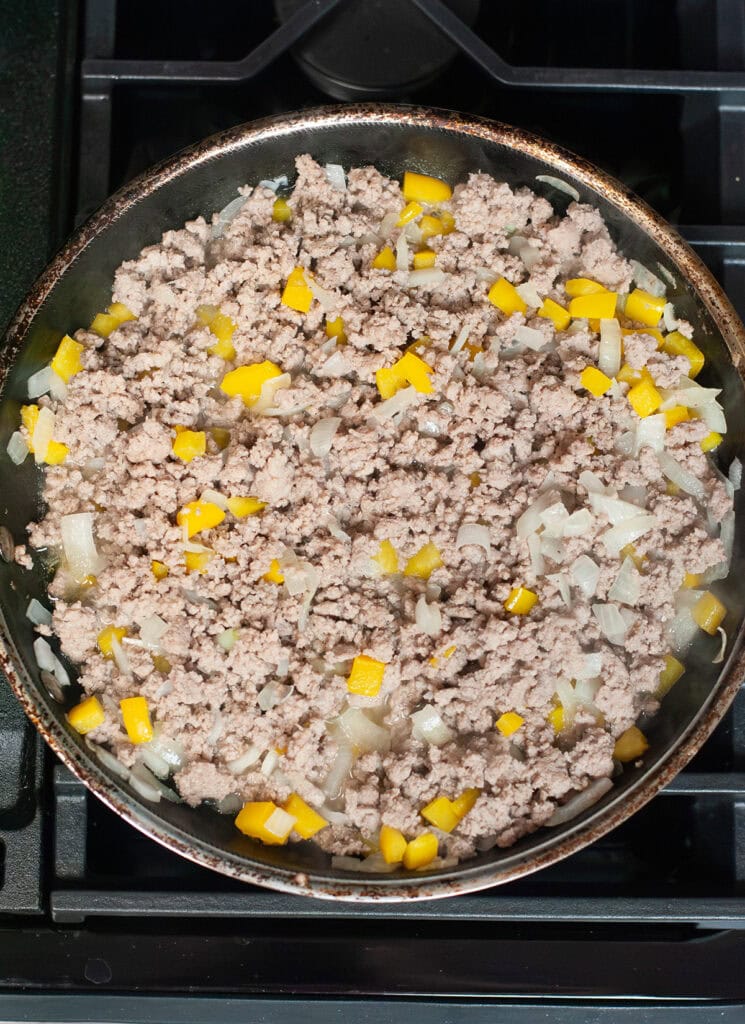 Cooked ground turkey with peppers and onions.