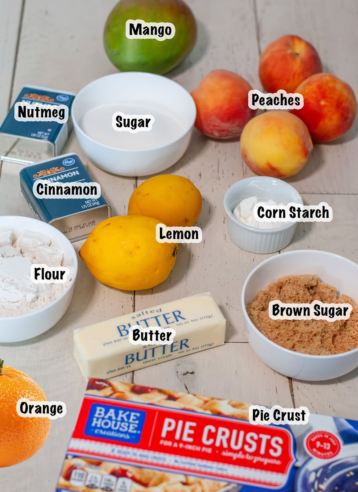 Ingredients laid out for making a peach mango pie.