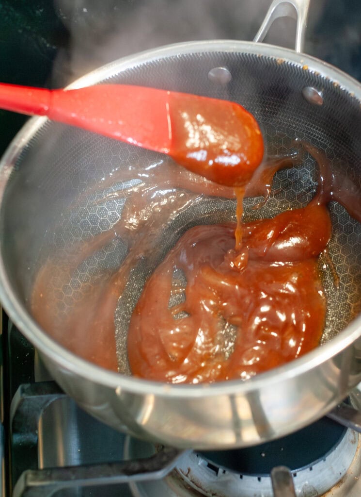 Cooked peach mango pie liquid in a pot.