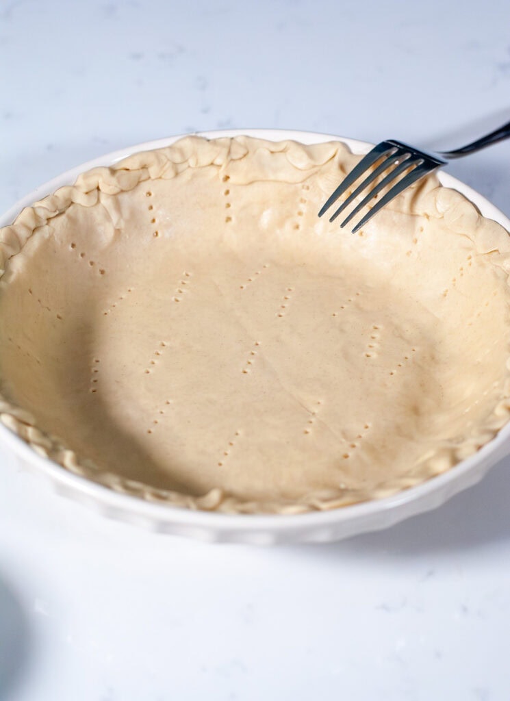 Holes poked into pie crust.