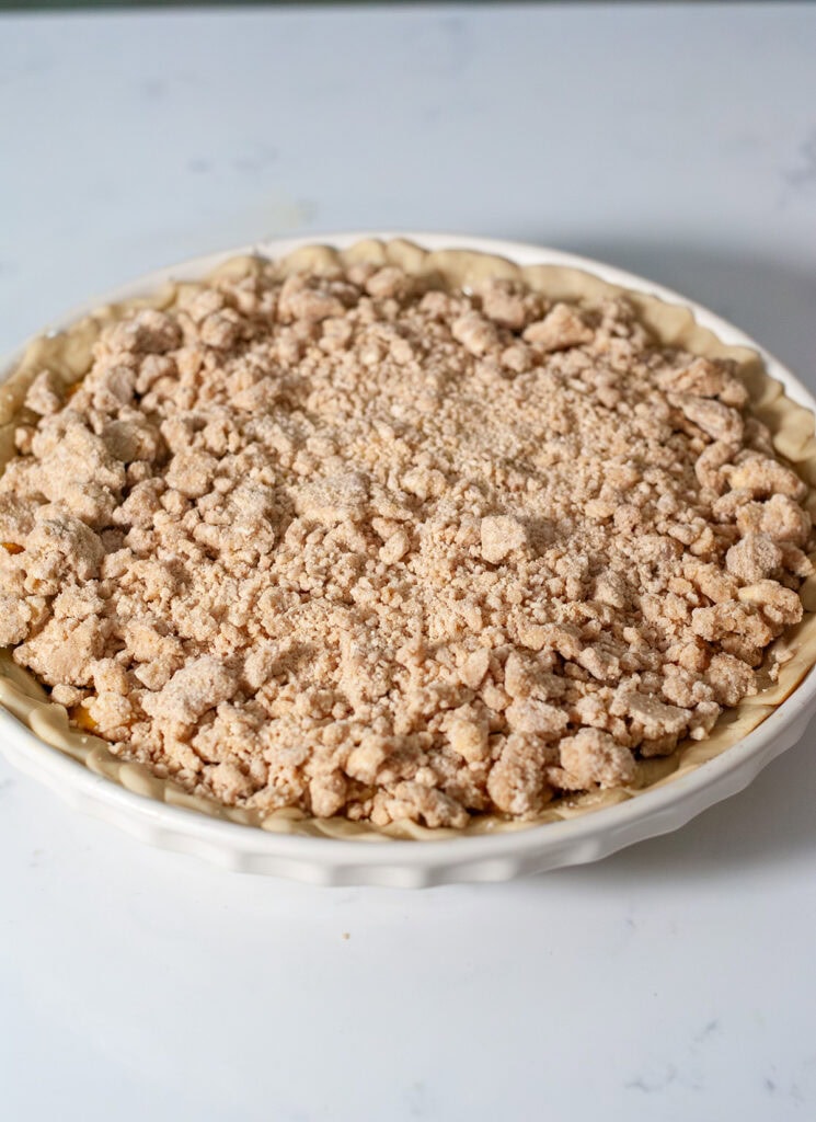 Crumble topped over peach mango pie.