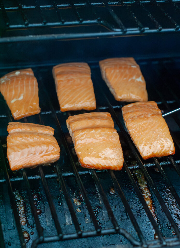 A meat thermometer checking temp of pellet grilled salmon.