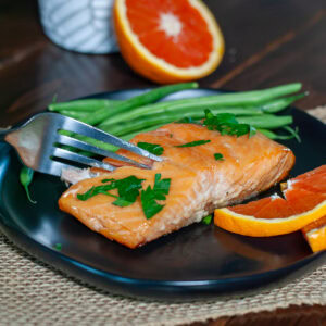 A fork full of pellet grilled salmon.