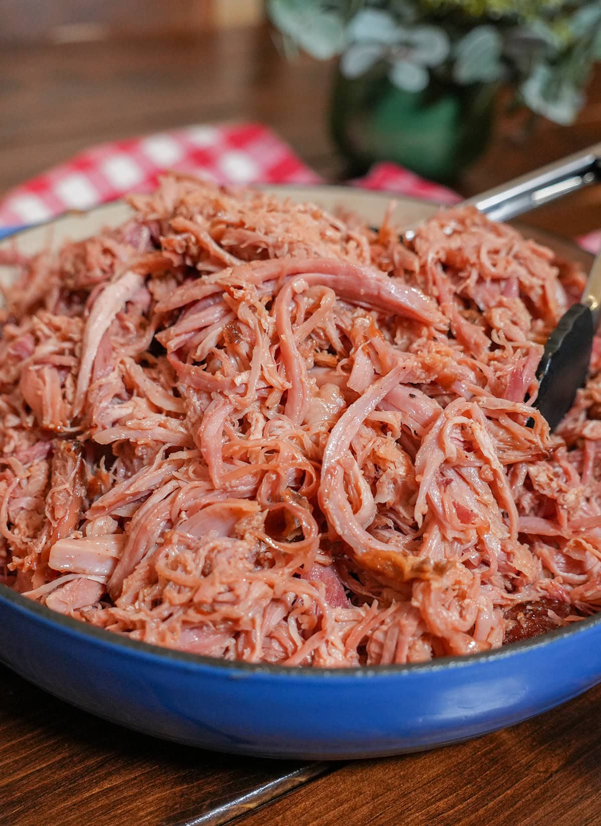 A juicy pulled ham in a blue bowl.