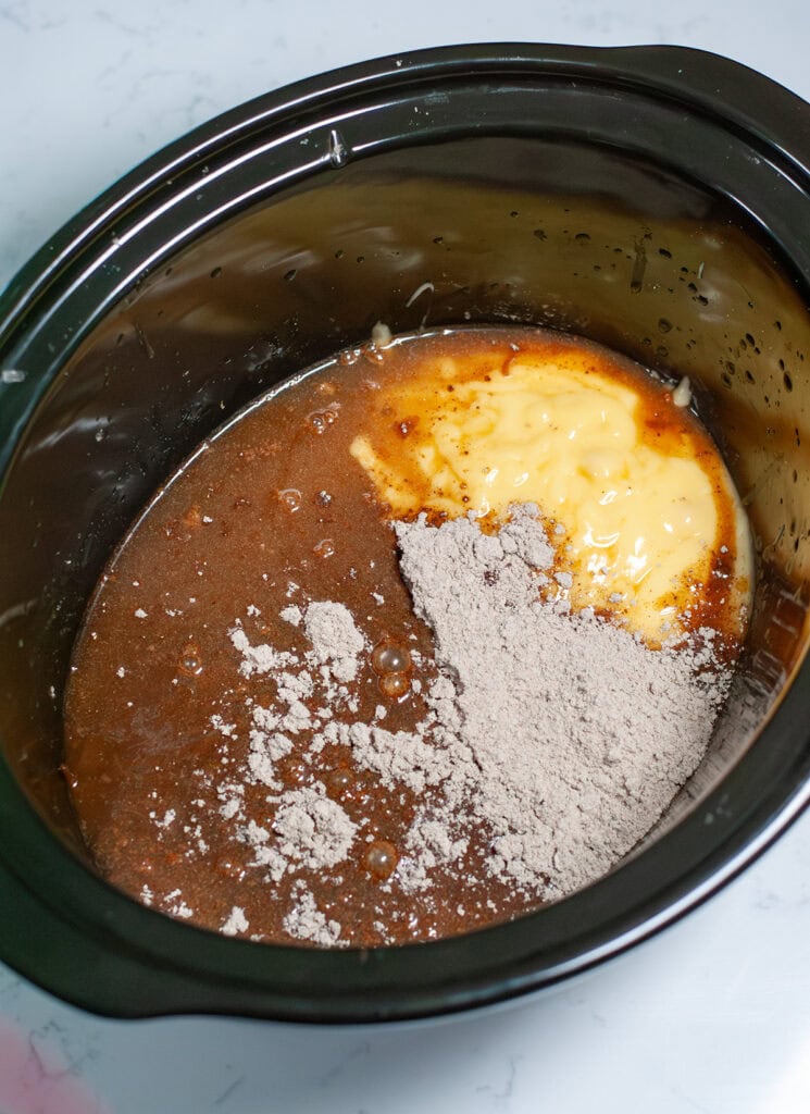 Sauce ingredients mixed together in a crock pot.