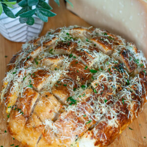 Cheesy stuffed garlic sourdough bread loaf.