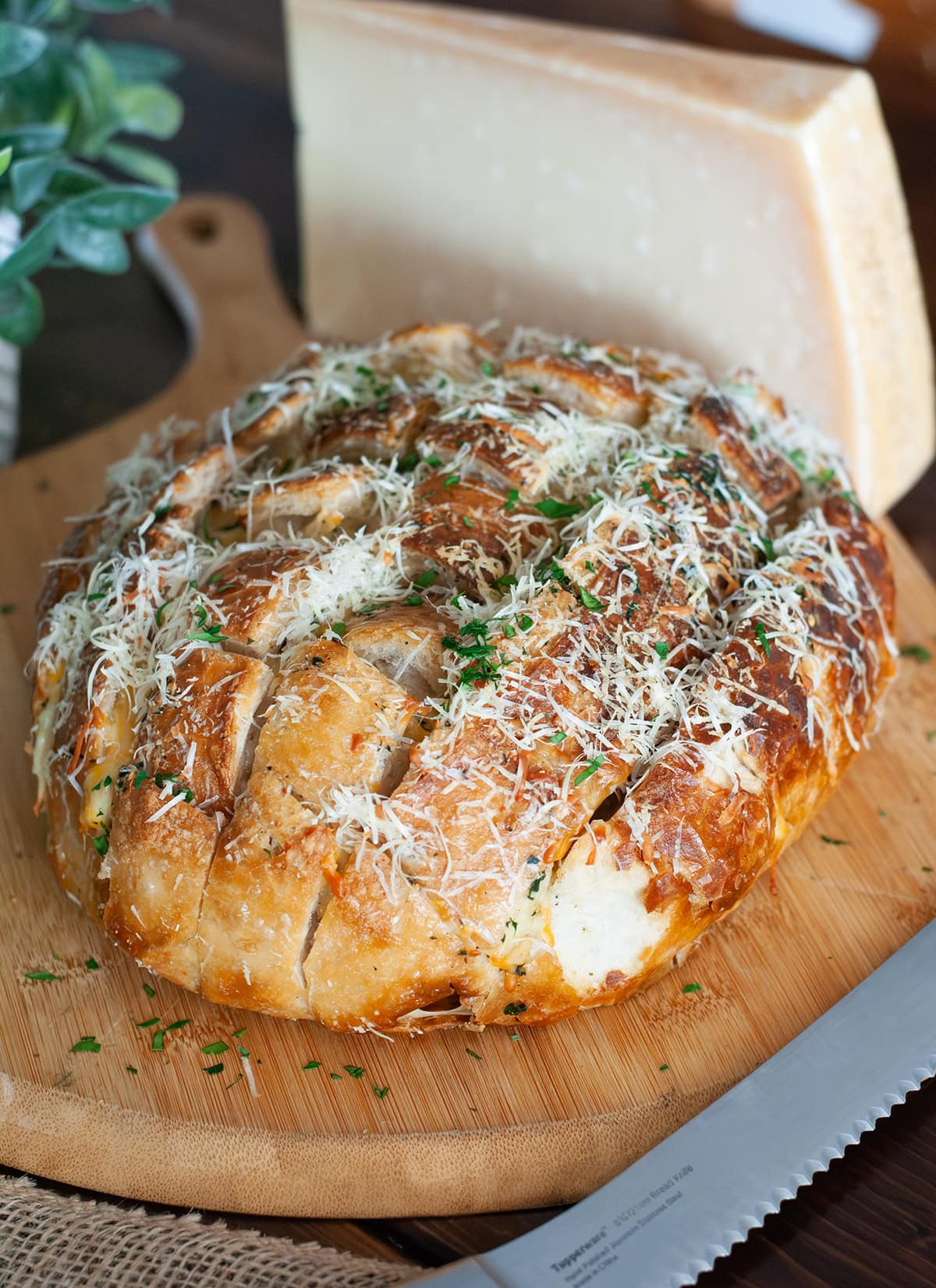 Stuffed garlic bread topped with parmesan cheese and parsley flakes.