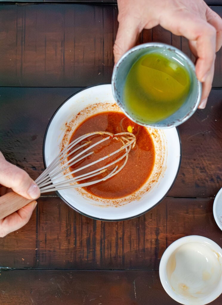 Oil pouring in sauce mixture.