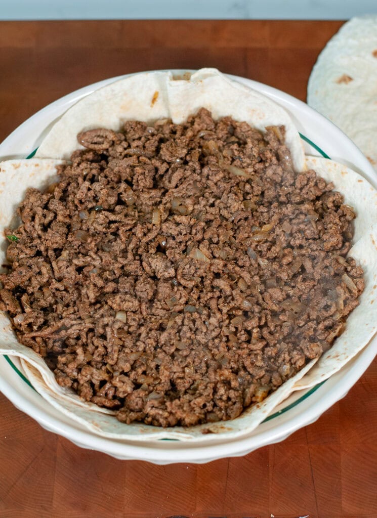 Meat mixture poured over refried beans.