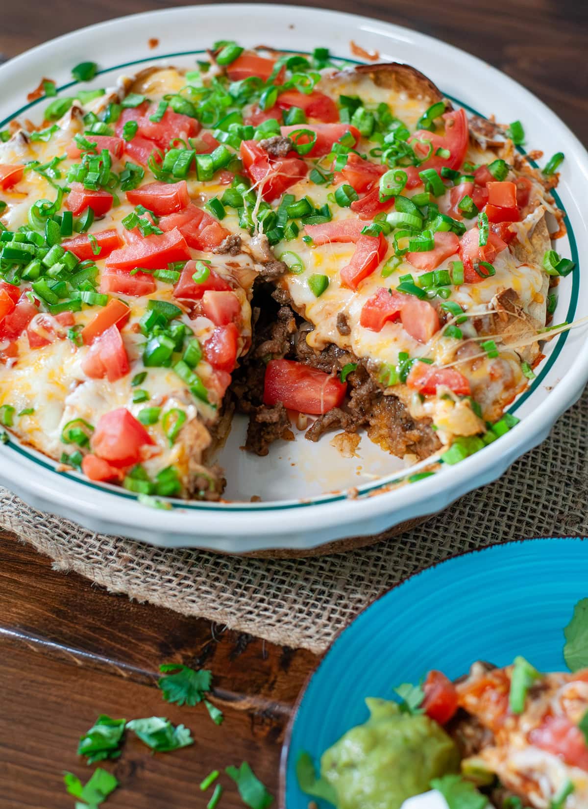 A taco pie topped with chives and cilantro.