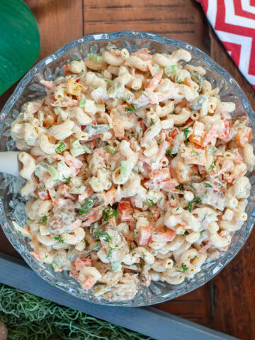 Chicken macaroni pasta salad topped with fresh dill.