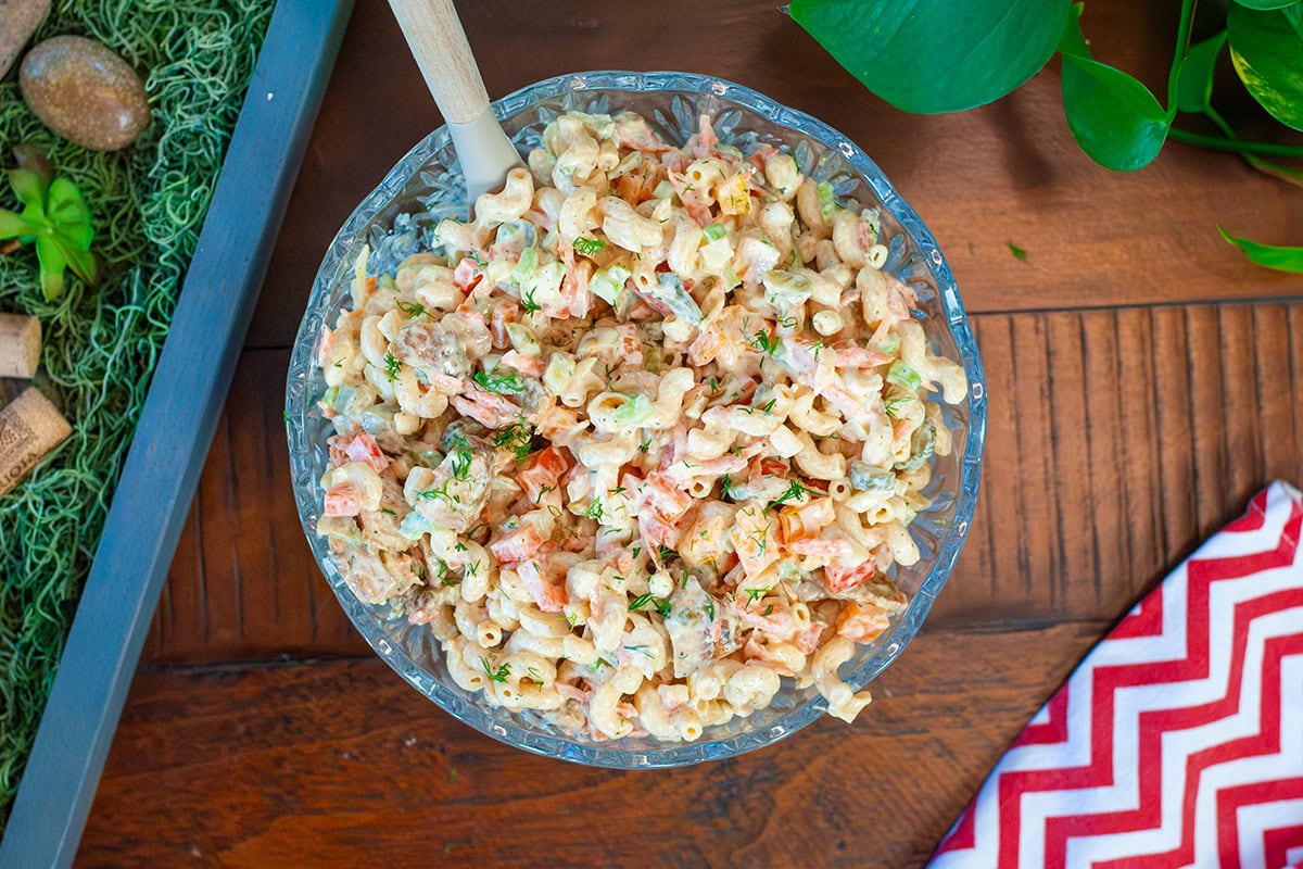 Chicken macaroni pasta salad in a bowl by a red cloth.