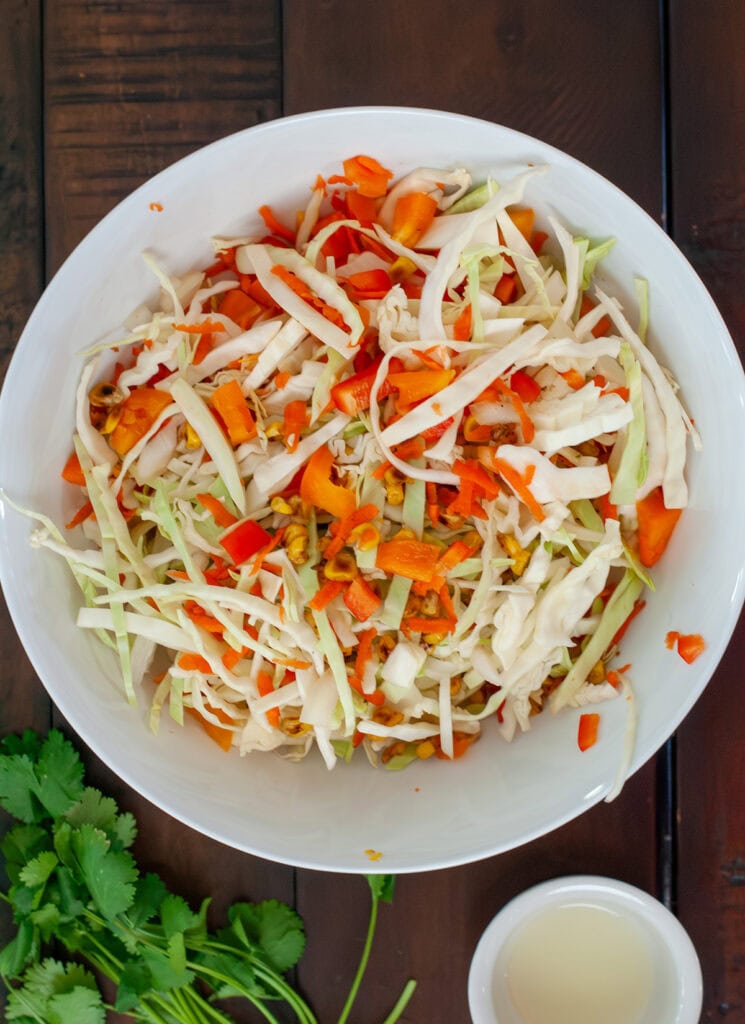 Sliced cabbage, corn and red peppers.