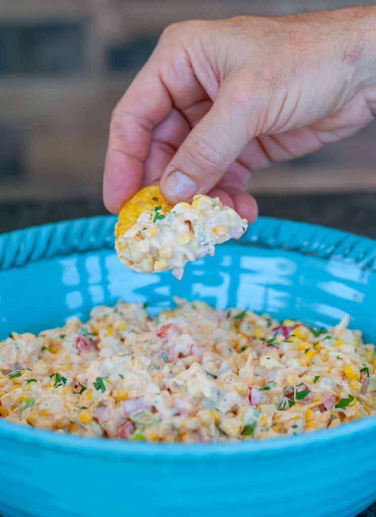 A close-up of corn dip in a blue bowl. 