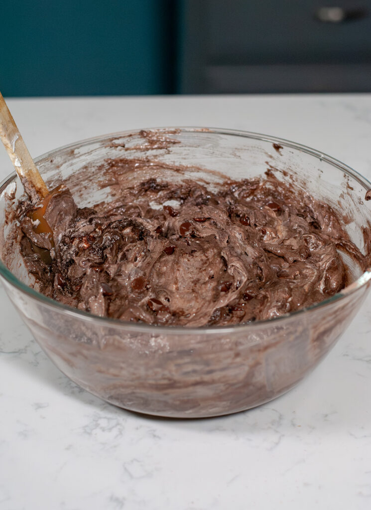 Cake mix in a glass mixing bowl with spatula.