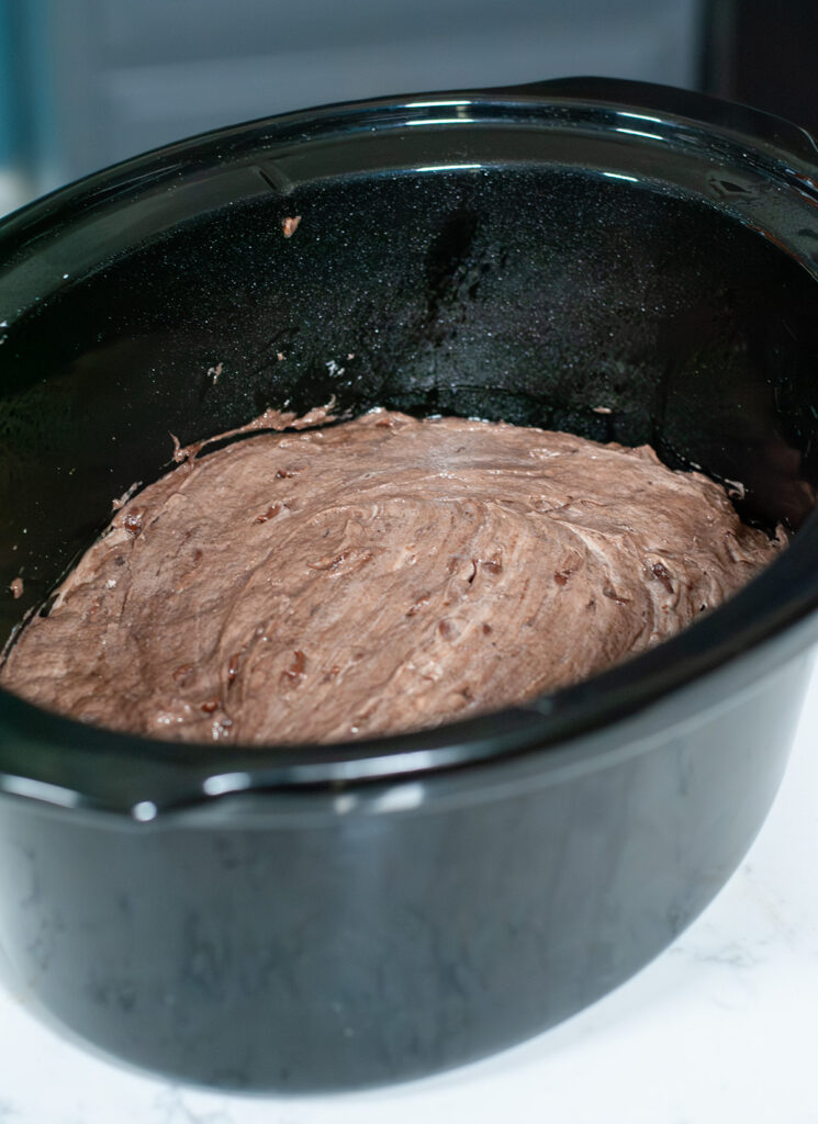 Cake mix spread evenly in a crockpot.