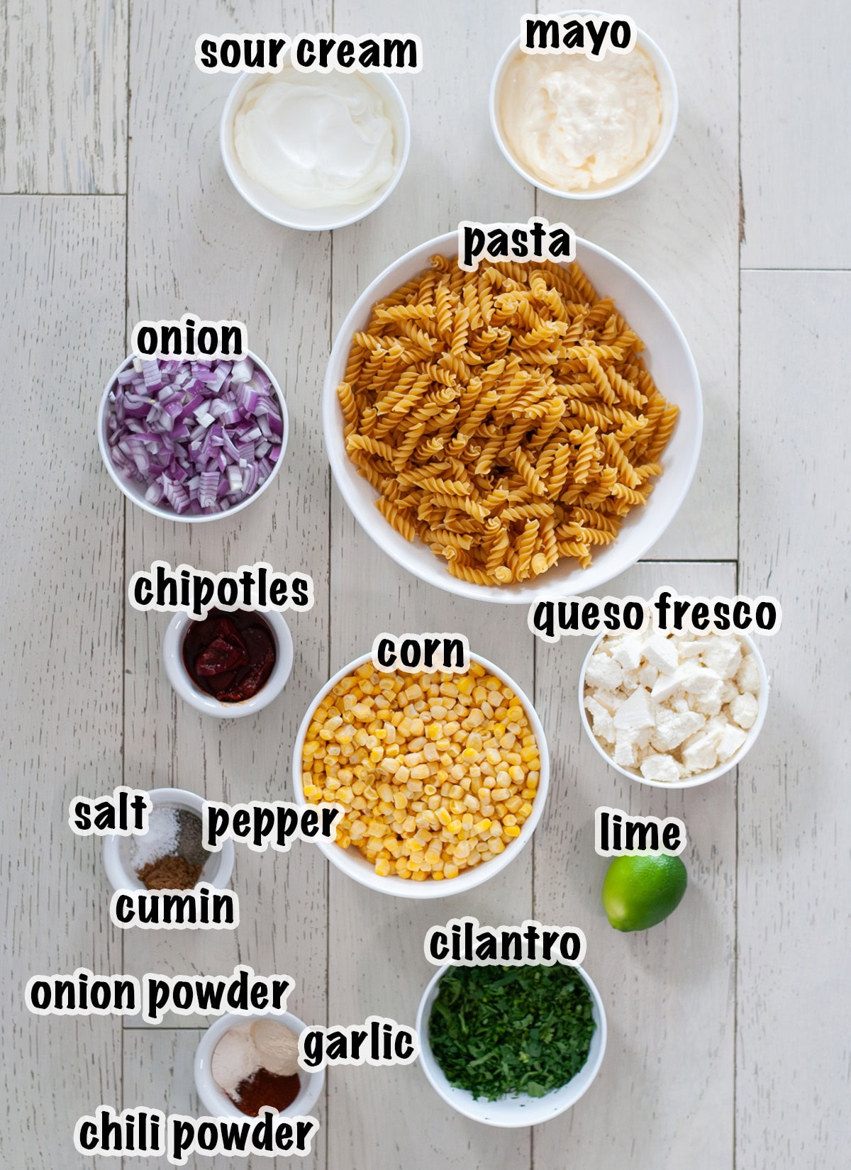 Labeled ingredients for making mexican street corn pasta salad.