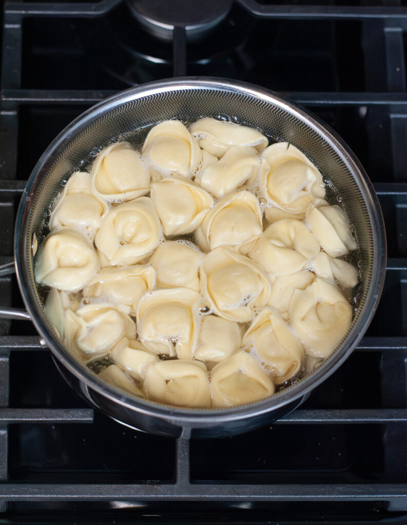 Tortellini Pasta cooking in pot.