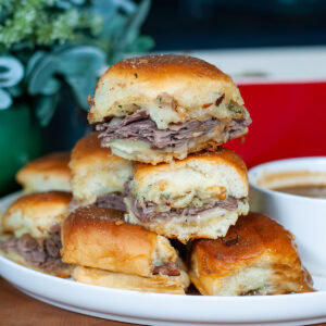 sliders with roast beef, cheese and seasoning.