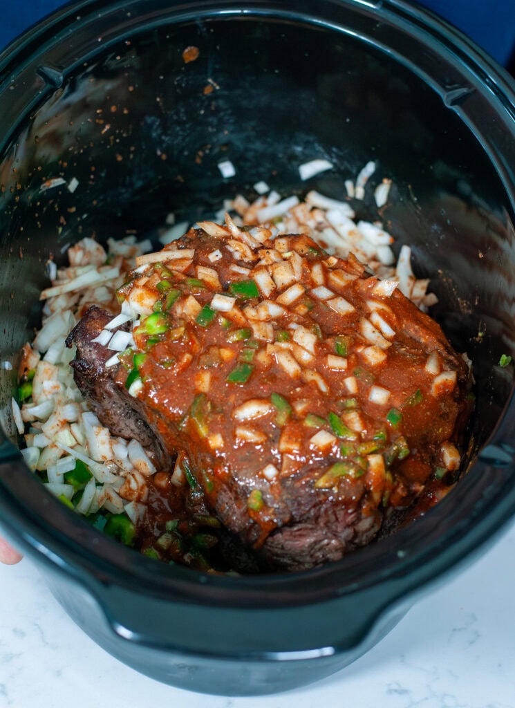 The roast, veggies, and sauce ready to start cooking in the crockpot. 