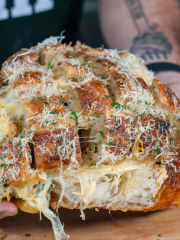 Stuffed Garlic bread topped with parsley and parmesan cheese.