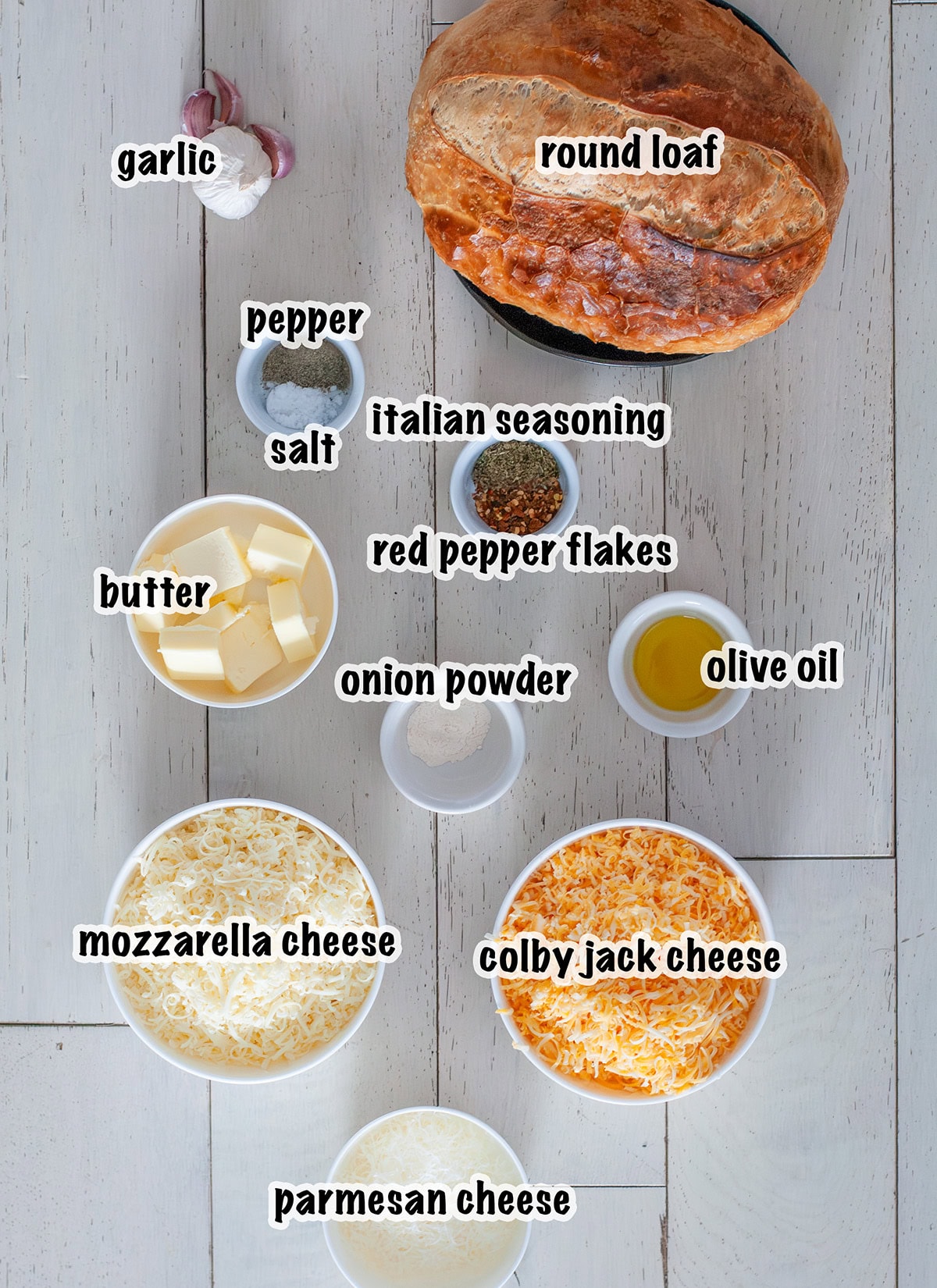 Labeled ingredients for making stuffed garlic bread with sourdough.