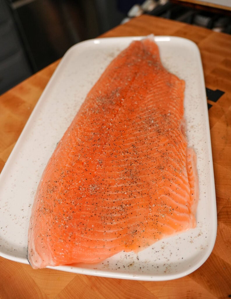 A seasoned piece of Salmon with salt and pepper for the Barbecue Salmon recipe.