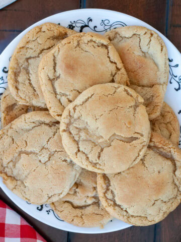 A plate of chocolate chipless cookies with milk.
