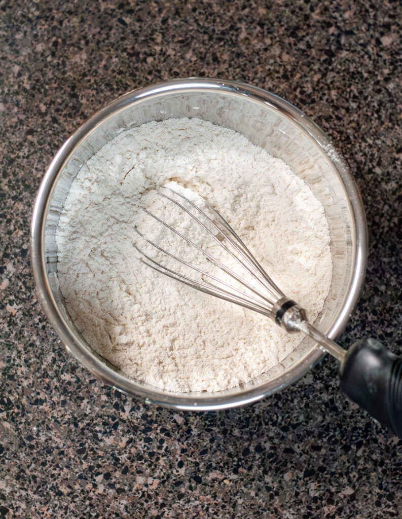 A bowl of the flour mixture with a whisk. 