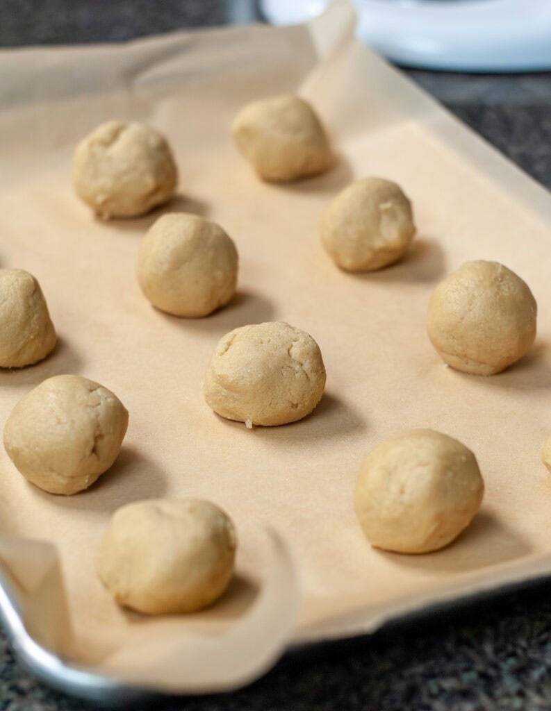Chocolate chipless cookie dough formed into round balls. 
