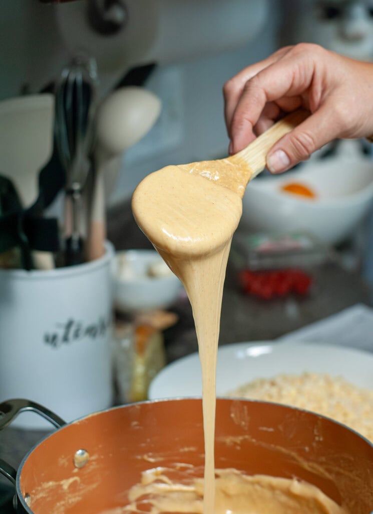 A spoon showing the consistency of the melted, smooth marshmallow mixture. 