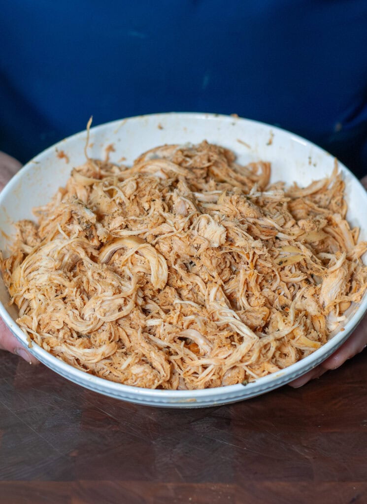 A bowl of shredded slow cooker chicken.  