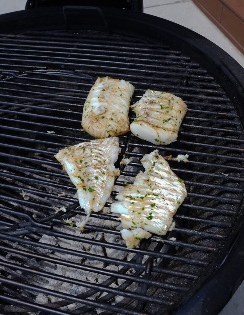 Cod fillet on the grill showing grill marks. 