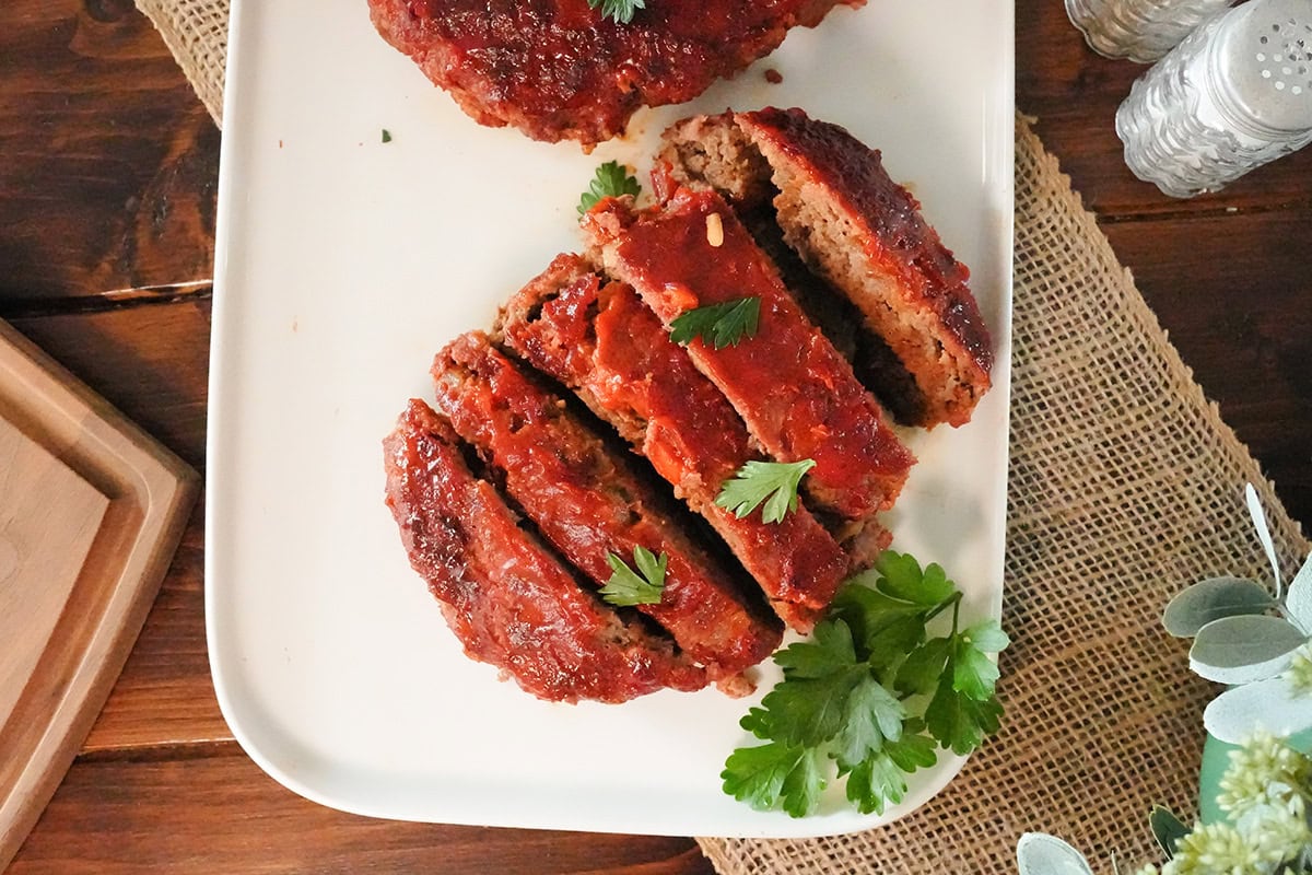 slices of grilled meatloaf on a plate with parsley.