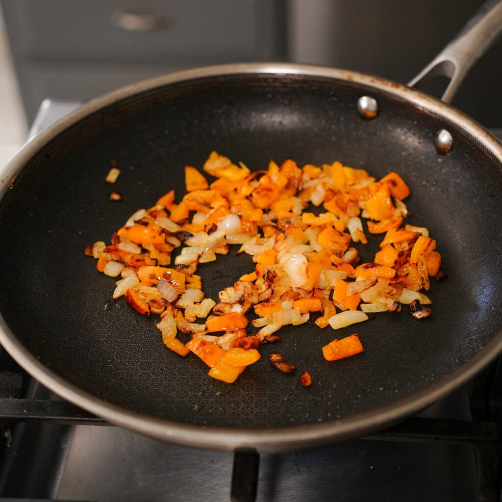 sautéed onions and bell pepper in a skillet.