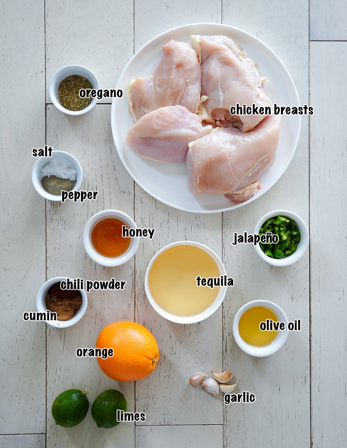 labeled ingredients in bowls for making margarita chicken.