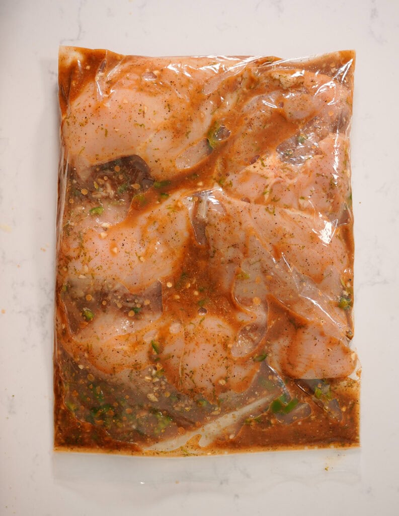 marinating chicken breasts in a bag.