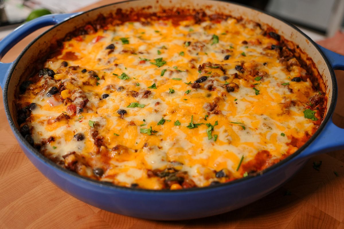 A finished picture of Skillet beef and rice topped with melted cheese. 