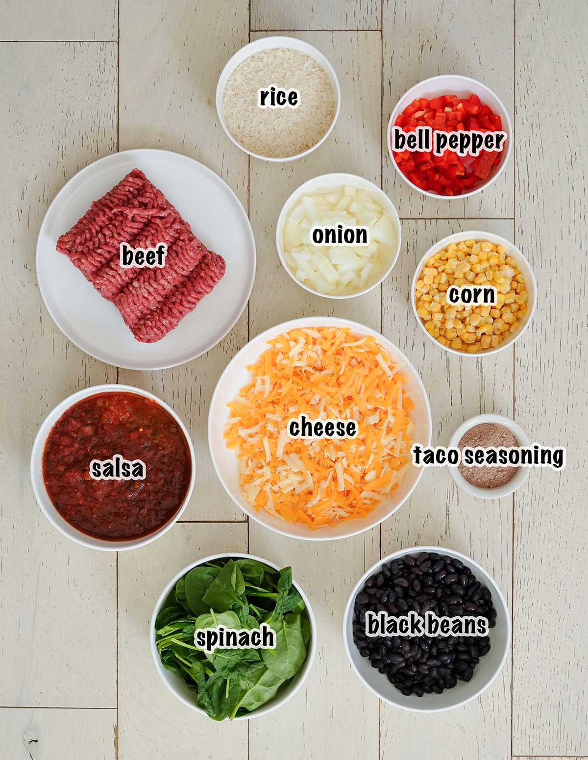 The ingredients for Mexican beef and rice in bowls. 